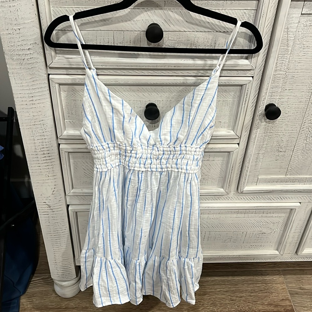 Brand new (with tags) summer mini dress with adjustable straps.